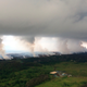 Sulfur dioxide plumes rising from fissures along the rift and accumulating in the cloud deck.